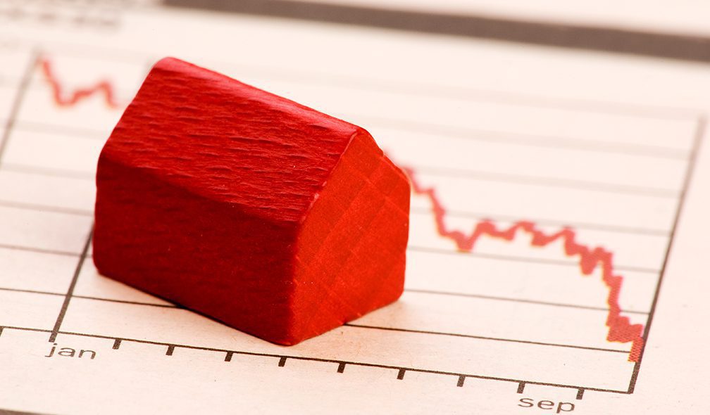 Housing market concept image with graph and toy house